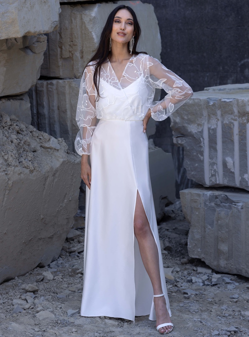 Floor-length bridal gown with satin skirt and floral bridal tulle blouse